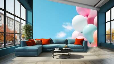 Pastel colors balloons bunch in blue sunny sky background with copy space Wall mural