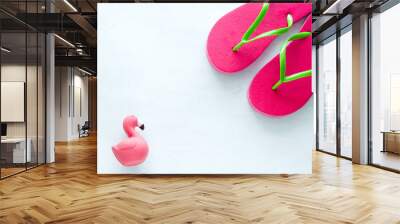 pink beach flip flops  and squishy toy  flamingo  on white  background copy space Wall mural