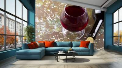 wine glass with red wine,   bottle of wine, wooden background Wall mural