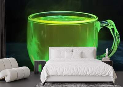 A steaming cup of glowing green liquid on a dark background. Wall mural