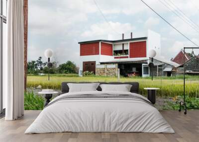 View of a house in a rice field Wall mural