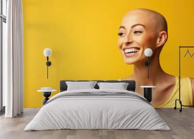 Happy smile beautiful girl with shaved bald head isolated on yellow background. World cancer day campaign background concept Wall mural