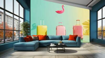 Minimalistic photo of three colorful luggage items and one inflatable flamingo floating in the air against an isolated pastel background. Wall mural