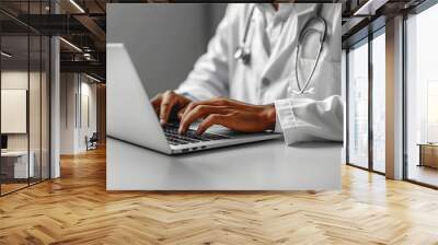 Photo of a doctor typing on a laptop with a blank screen. Wall mural