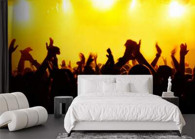 silhouettes of concert crowd in front of bright stage lights Wall mural