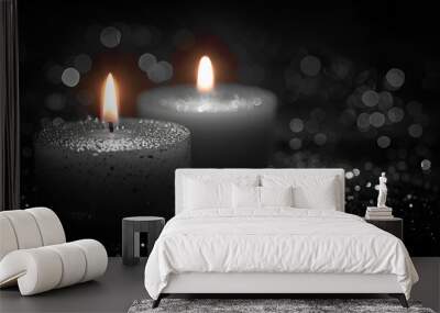 a close-up of two white candles on a black background. The candles are lit and appear to be floating in the air. Wall mural