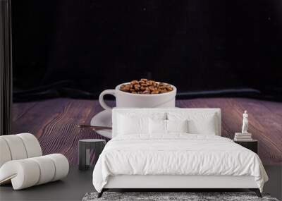 coffee beans in a white cup on a wooden table Wall mural