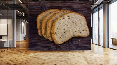 sliced bread on a dark wood table Wall mural