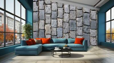 Dark grey cobblestone pavement from old smooth stones as background top view close up Wall mural