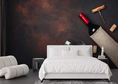 Bottle of wine, corkscrew and corks, on rusty background top view Wall mural