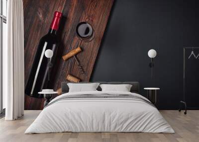 Bottle of wine corkscrew and wineglass on rusty background Wall mural