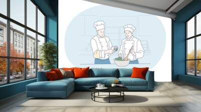 Cooking, professional chef, restaurant concept. Young man and woman professional cooks in aprons and hats cooking healthy salad or dish together in kitchen of cafe Gourmet, delicious, tasty menu  Wall mural