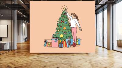 Decorating and preparing for winter holidays concept. Smiling girl standing decorating Christmas tree and collecting New year presents in colorful boxes vector illustration  Wall mural