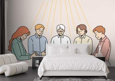 Group of diverse people sit at table praying together. Men and women engaged in prayer ask god for fate and fortune. Faith and religion. Vector illustration.  Wall mural