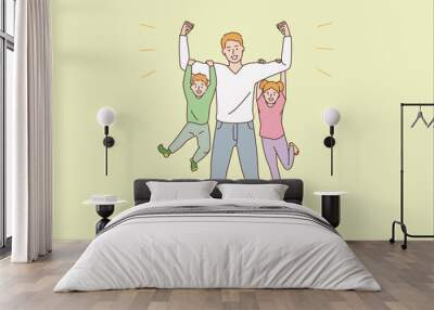 Happy parenthood and childhood concept. Young smiling man father dad cartoon character standing holding happy children son and daughter on hands vector illustration  Wall mural