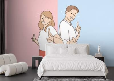 Positive emotions and good vibes concept. Young smiling cheerful couple woman and man cartoon characters standing pointing at camera showing thumbs up sign vector illustration  Wall mural