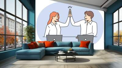 Smiling businesspeople give high five working together in office. Happy employees celebrate shared win coworking at workplace. Vector illustration. Wall mural