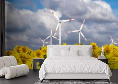 Wind power plants behind a field of sunflowers panorama Wall mural