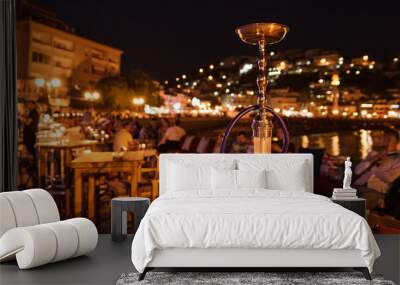 shisha on the table in restaurant, in the background city Ulcinj in Montenegro at night. Wall mural