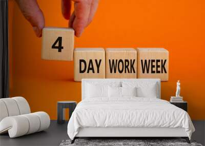 4 day work week symbol. Businessman holds the cube with words '4 day work week'. Beautiful orange background. Copy space. Business and 4 or 5 day work week concept. Wall mural