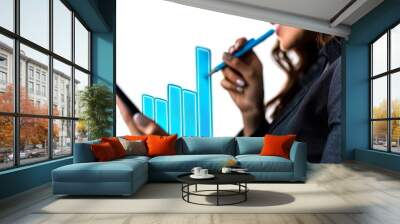 A businesswoman analyzes data on a virtual screen while holding a tablet. Wall mural