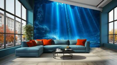 A dark karst cave inside a mountain with blue beams of light coming from above. Travel, wild nature, subterranean themes. Wall mural