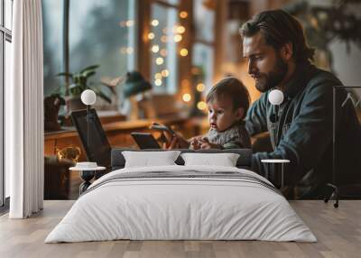 A father and his little son work at home on a laptop and use the phone Wall mural