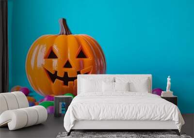 An animated 3D rendering of a Halloween pumpkin, Jack O Lantern, surrounded by candy and gummy worms on a blue background. Wall mural