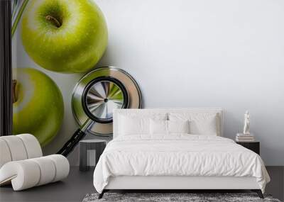 An apple with a green stethoscope sitting on a transparent background. Wall mural