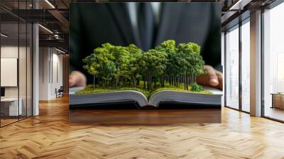 An environmental responsibility and sustainable business practice symbol is shown on the hand of a businessman with a 3D ecological plan. Wall mural