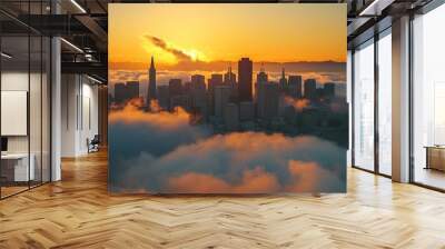 At dawn, a misty urban skyline with silhouetted buildings and distant hills glows softly in golden light Wall mural