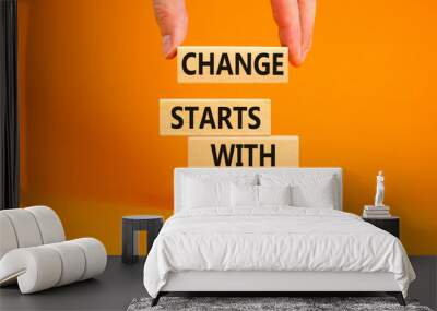 Change starts with you symbol. Concept words Change starts with you on wooden blocks on beautiful orange table orange background. Businessman hand. Business motivational change starts with you concept Wall mural