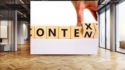 Content and context symbol. Businessman turns wooden cubes and changes the word context to content. Beautiful white table, white background. Business and content and context concept. Copy space. Wall mural