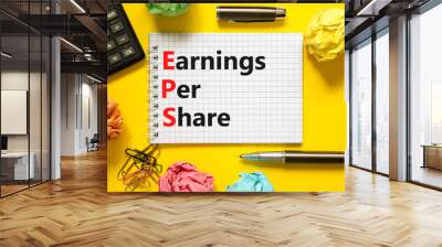 eps earnings per share symbol. concept words eps earnings per share on white note on a beautiful yel Wall mural