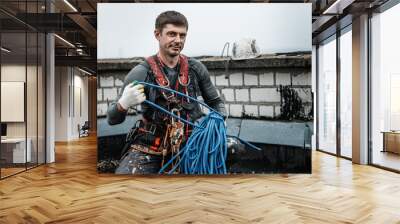 Male worker rope access industrial working at height tank oil wearing harness, helmet safety equipment rope Wall mural