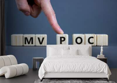 MVP vs POC symbol. Businessman pushes the cube with words MVP, minimum viable product and POC, proof of concept. Beautiful grey background. Business and MVP vs POC concept, copy space. Wall mural