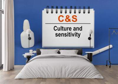 On a blue background, a pen, tablets and a notepad with the inscription - Culture and sensitivity Wall mural