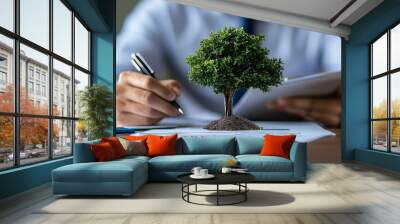 On a financial chart, a tree represents sustainable business practices and environmental protection. Wall mural