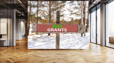 Planning 2025 grants new year symbol. Concept words 2025 Grants on beautiful wooden old retro vintage road sign. Beautiful winter forest background. Business 2025 grants new year concept. Copy space. Wall mural