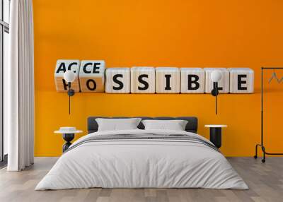 Possible and accessible symbol. Turned wooden cubes and changed the word possible to accessible. Business and possible or accessible concept. Beautiful orange background, copy space. Wall mural