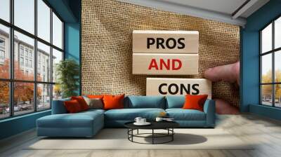 Pros and cons symbol. Wooden blocks with words 'Pros and cons'. Beautiful canvas background, businessman hand. Business, pros and cons concept, copy space. Wall mural