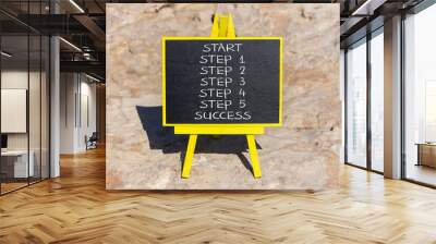 Start and step to success symbol. Concept word Start step 1 2 3 4 5 Success on beautiful black blackboard on beautiful stone background. Business start and step to success concept. Copy space. Wall mural