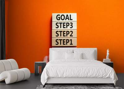 Strat, step and goal symbol. Concept words Start step 1 2 3 goal on wooden blocks on a beautiful orange table orange background. Businessman hand. Business start step 1 2 3 to goal concept. Wall mural