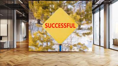 Successful symbol. Concept word Successful on beautiful yellow road sign. Beautiful winter snow forest background. Business successful concept. Copy space. Wall mural