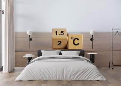 Symbol for limiting global warming. Turned a cube and changed the expression '2 C' to '1.5 C', or vice versa. Concept. Beautiful wooden table, white background, copy space. Wall mural