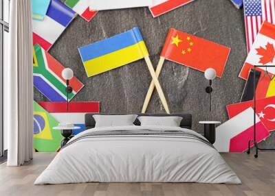 The concept is diplomacy. In the middle among the various flags are two flags - China, Ukraine Wall mural