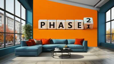 Time for Phase 2. Turntd a cube and changed the word 'Phase 1' to 'Phase 2'. Beautiful orange background. Business concept. Copy space. Wall mural