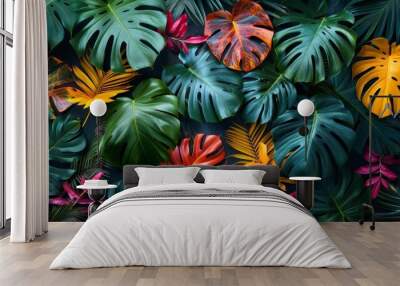 Tropical leaves greenery over a black background with colorful leaves Wall mural