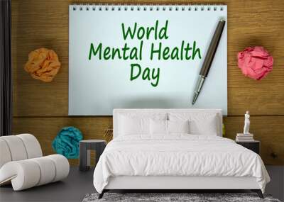 White note with inscription 'World Mental Health Day' on beautiful wooden table, colored paper, metalic pen and wooden calender with date october 10. Concept. Wall mural