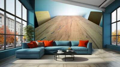 Wooden coffee table separated by line, two chairs, social distance. Concept of the new normal after covid-19. Wall mural